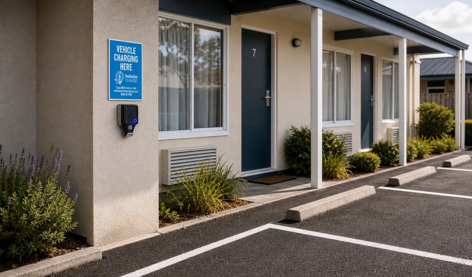 Destination Charge outlet and vehicle charging sign installed at a motel parking area